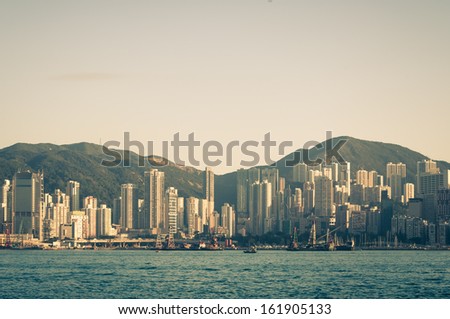 The afternoon sun falls across Victoria Harbor in Hong Kong.