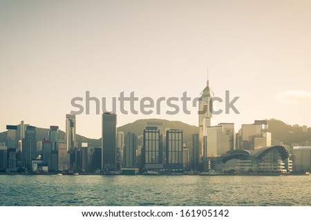 The afternoon sun falls across Victoria Harbor in Hong Kong.