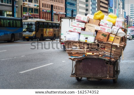 SEOUL, SOUTH KOREA - AUGUST 17: A cart is overloaded with broken down cardboard boxes in the Gangnam district of Seoul. Photo taken on August 17, 2013 in Seoul, South Korea.