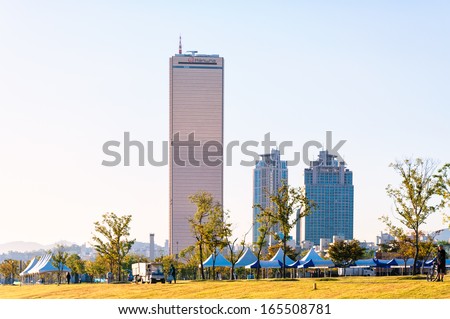 SEOUL, SOUTH KOREA - OCTOBER 3: The skyscrapers of Yeouido rise up beyond the park along the Han River. Photo taken October 3, 2013 in Seoul, South Korea.