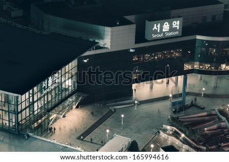 Night time commuters pass in and out of Seoul Station.