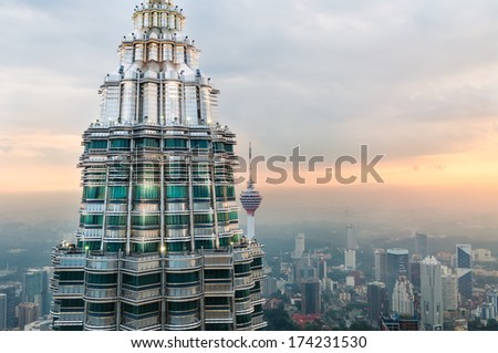 KUALA LUMPUR MALAYSIA DECEMBER 26 The setting sun gleams off of the second Petronas Tower and KL Tower in the distance Photo taken December 26 2013 in Kuala Lumpur Malaysia KUALA LUMPUR MALAYSIA DECEMBER 26 The setting sun gleams off of the second Petronas Tower and KL Tower in the distance Photo taken December 26 2013 in Kuala Lumpur Malaysia