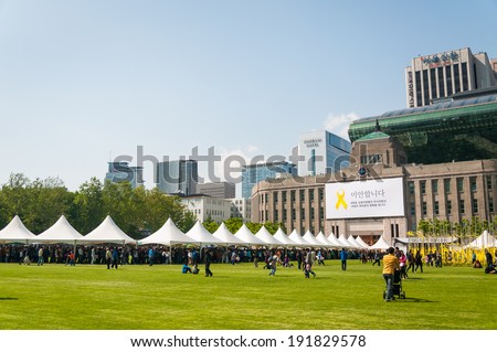 SEOUL, SOUTH KOREA - MAY 5: A long queue of visitors wait outside City Hall to pay their respects to the victims of the Sewol ferry tragedy on May 5, 2014 in Seoul, South Korea.