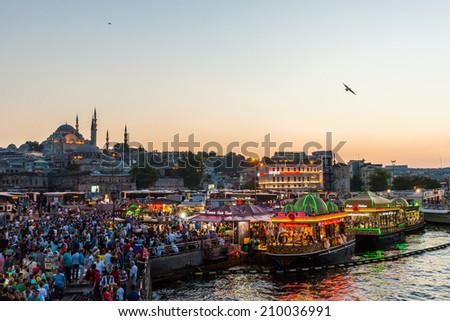 ISTANBUL, TURKEY - JULY 29: Hundreds of tourists and local Turks hang out along the Bosphorus as night comes on on July 29, 2014 in Istanbul, Turkey.