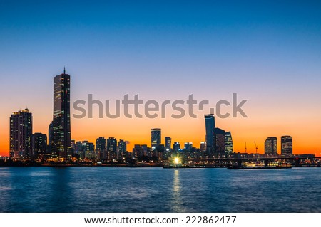 The sun sets behind the skyscrapers of Seoul, South Korea.
