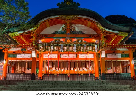The haiden, or the hall of worship, of Fushimi Inari shrine lit up in early morning in Kyoto, Japan.