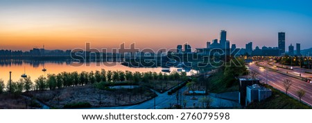 Panorama of the sun rising over the Han River and the National Assembly of South Korea in Seoul.