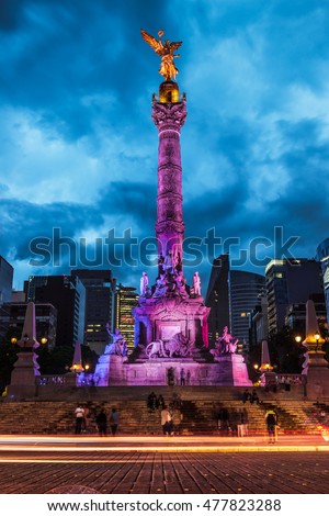 Night traffic drives past the Angel of Independence in Mexico City, Mexico.