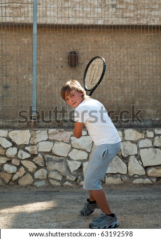 young tennis player in action .