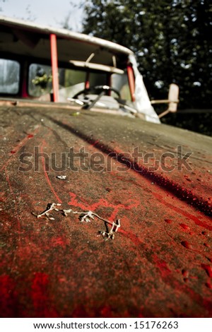 red car in a junk yard