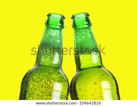 two beers making a toast on yellow backgroound
