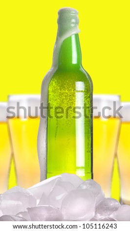 Open beer bottle with ice and foam on a white background