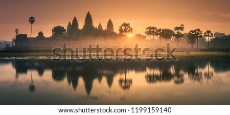 Sunrise view of popular tourist attraction ancient temple complex Angkor Wat with reflected in lake Siem Reap, Cambodia. Clipping path of sky
