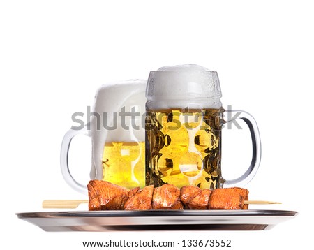 fresh grilled meat dishes with beer glass isolated on a tray