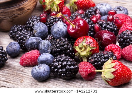 Tasty Summer Fruits On A Wooden Table. Cherry, Blue Berries, Strawberry, Raspberries, Blackberries, Pomegranate