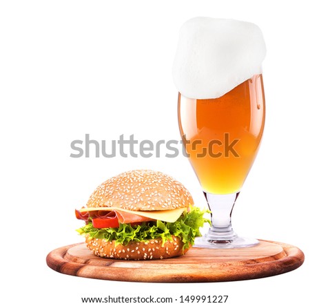 Closeup of homemade burger and a cold beer with foam