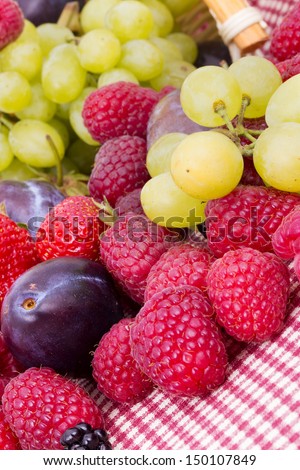tasty summer fruits.  Strawberry, raspberry, blackberries, grapes, plum