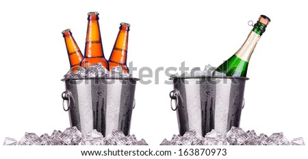 Beer and champagne bottles in ice bucket isolated on white