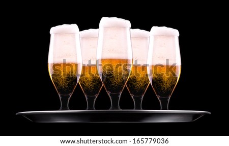 tray with Beer into glass on a black