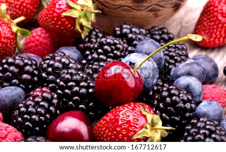 Tasty Summer Fruits On A Wooden Table. Cherry, Blue Berries, Strawberry, Raspberries, Blackberries, Pomegranate