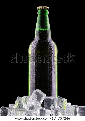 bottles of beer on ice on black background