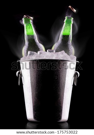 Beer bottles in ice bucket isolated on black
