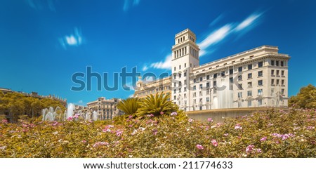 Fountain in Barcelona with blue sky and flowers
