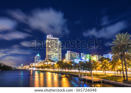 Miami south beach street view with water reflections at night