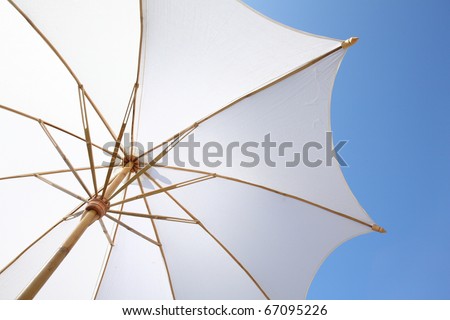 white beach umbrella with blue sky