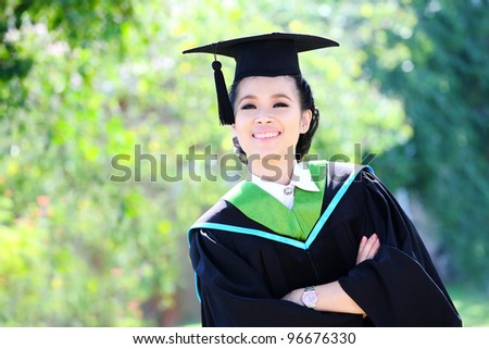 Portrait of a graduation student looking up outdoors