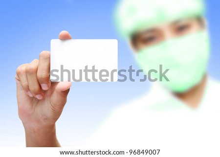female holding blank business card in hand with mask, medical concept.