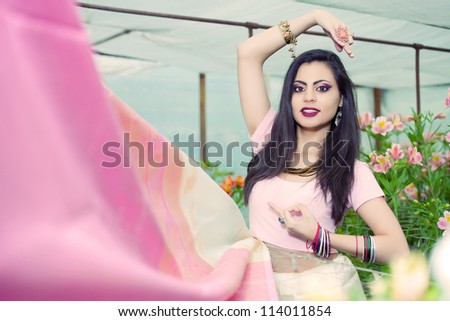 beautiful indian girl in the indian national dress on greenhouse