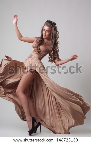 Beautiful hair, Sexy woman in fluttering gold dress