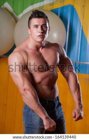 Muscular guy in fitness club