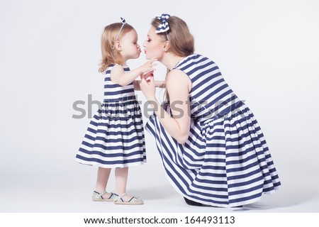 Young mother playing with daughter