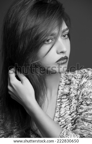 Fashion portrait of beautiful woman in knitted sweater