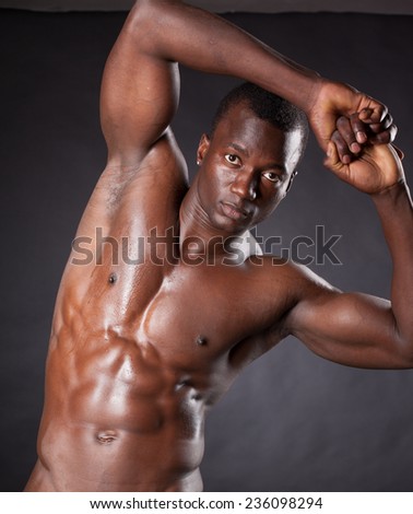 Beautiful and muscular black man in dark background