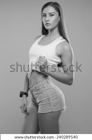beautiful young sporty muscular woman, isolated on white background