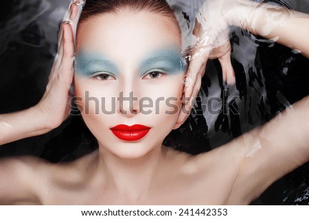 Attractive woman in water with glamor make-upAttractive woman in water with glamor make-up