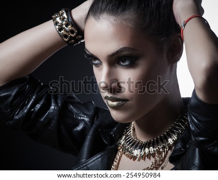 Brutal beautiful sexy woman in a leather clothes