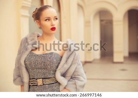 fashion woman with red lips walking in the city