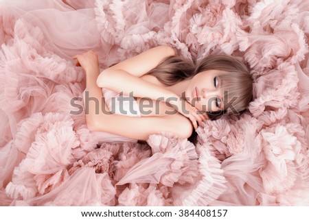 creative portrait of a fashion woman in gorgeous long pink dress