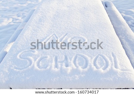 No School carefully printed in fresh snow indicates winter weather has closed local schools.