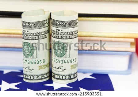 American dollars placed near colorful education symbols and on United States flag to reflect strategic financial policy to invest in jobs and critical career training.