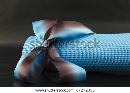 Blue yoga with a blue and brown ribbon on a black background is a sharing of yoga\'s pleasures
