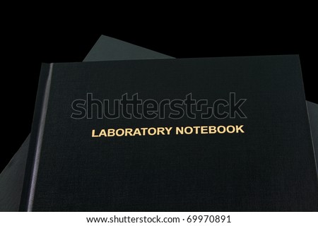 Science, technology, engineering and math studies depicted with two laboratory notebooks with gold lettering visible on one;