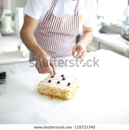 chef preparing delicious chocolate cake  at kitchen