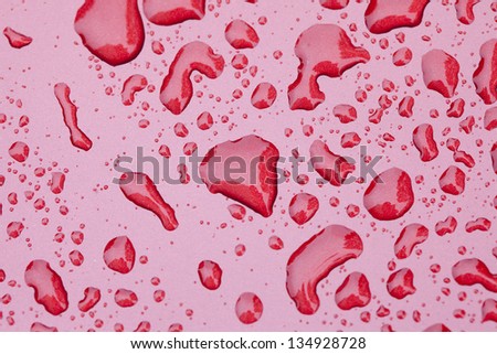 water drop on red painting surface background