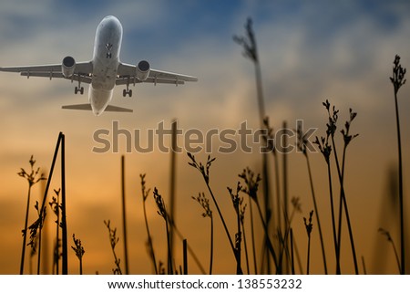 Airplane take off  from airport in sunset