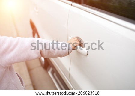 Young child boy opening the car door